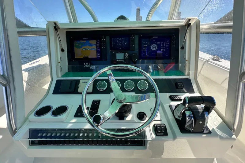 Slide: The Image of 2013 SeaVee 39B Center Console helm with navigation screens and controls. - 31