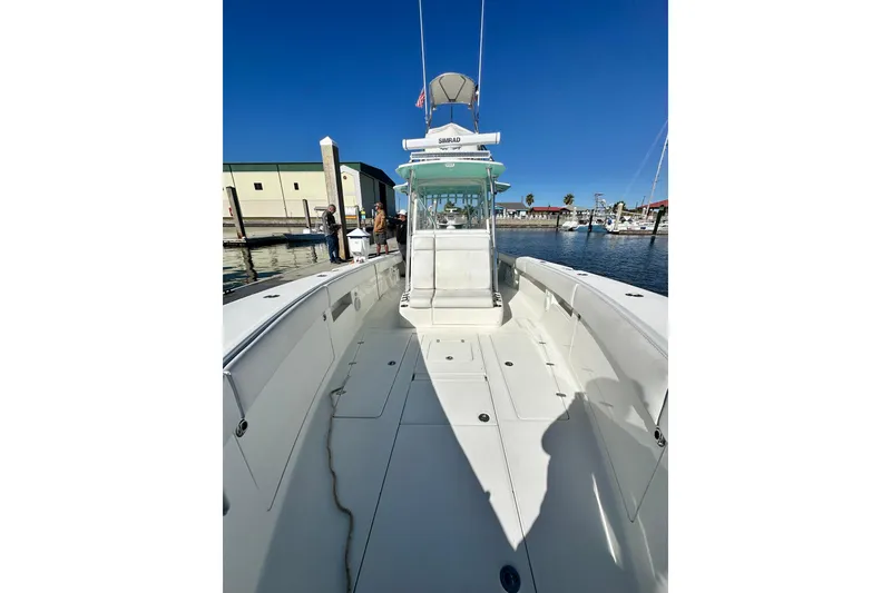 Slide: The Image of 2013 SeaVee 39B Center Console boat docked at marina under clear blue sky. - 36