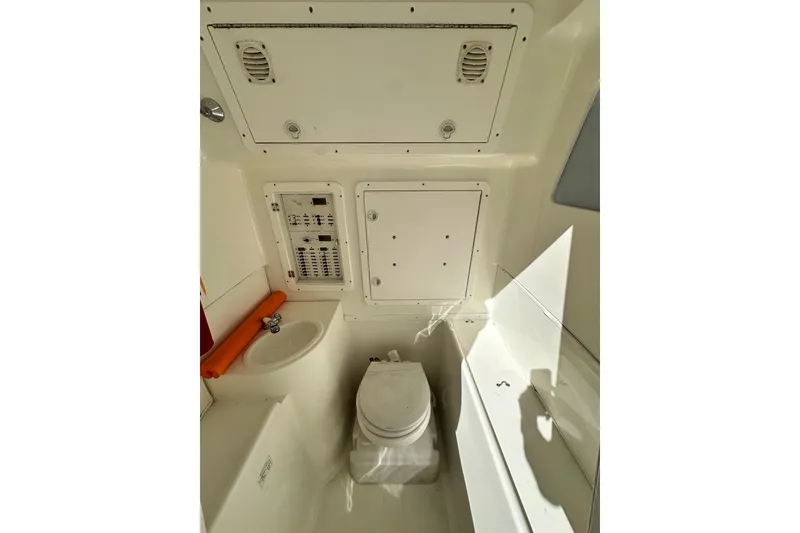 Slide: The Image of 2013 SeaVee 39B Center Console interior with toilet and control panel. - 38