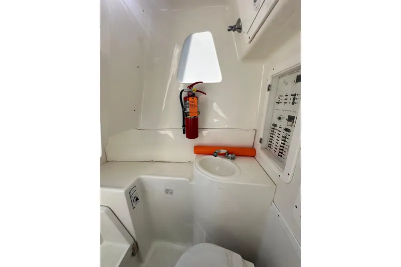 Slide: The Image of 2013 SeaVee 39B Center Console interior with sink, fire extinguisher, and control panel. - 39