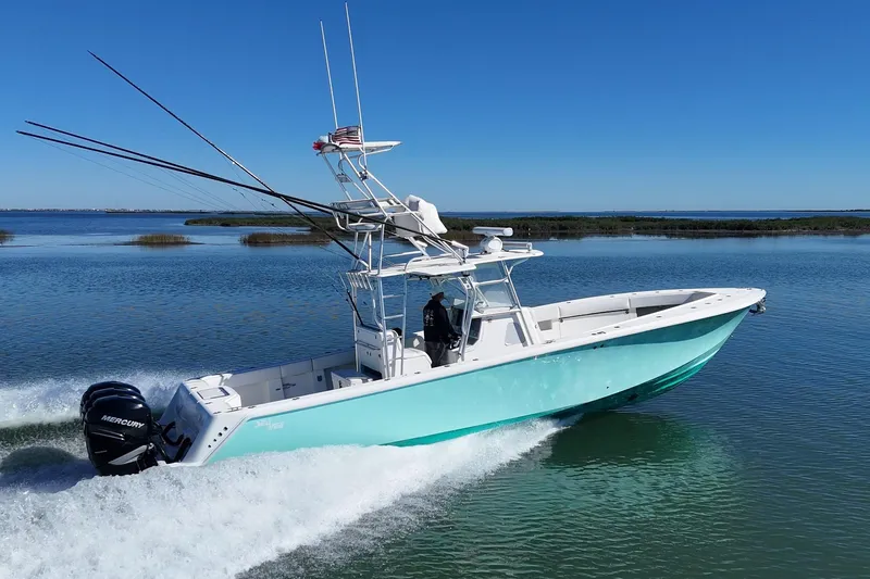 Slide: The Image of 2013 SeaVee 39B Center Console boat cruising on calm waters. - 4