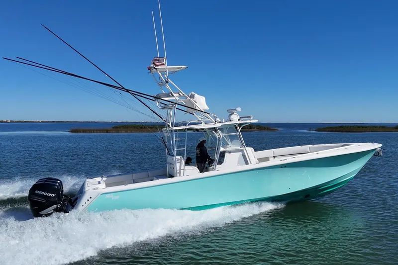 Slide: The Image of 2013 SeaVee 39B Center Console boat cruising on open water, side view. - 8