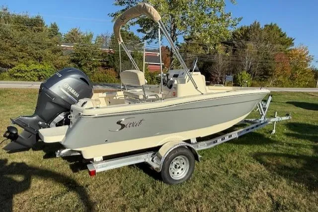 Slide: The Image of 2026 Scout 188 Sportfish boat on trailer with Yamaha outboard motor, parked on grass. - 2