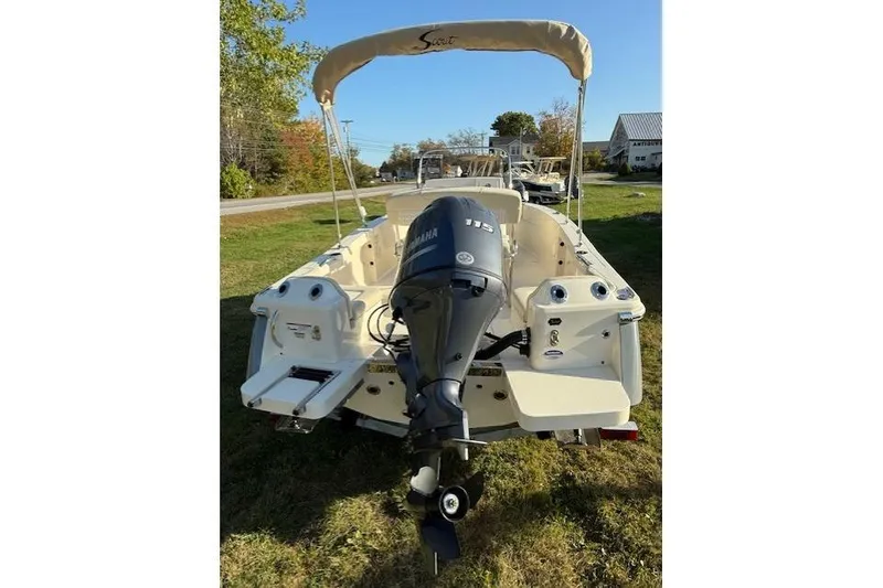 Slide: The Image of 2026 Scout 188 Sportfish boat with Yamaha 115 outboard motor, parked on grass. - 3