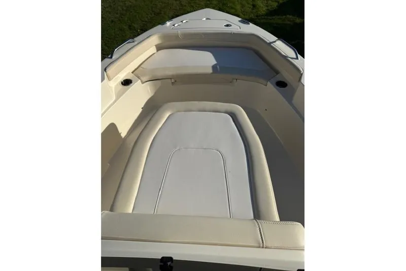 Slide: The Image of 2026 Scout 188 Sportfish boat interior with cushioned seating and cup holders. - 8