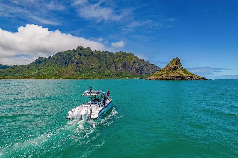 Slide: The Image of 2021 Axopar Suntop Brabus Trim cruising near lush island and turquoise waters. - 3