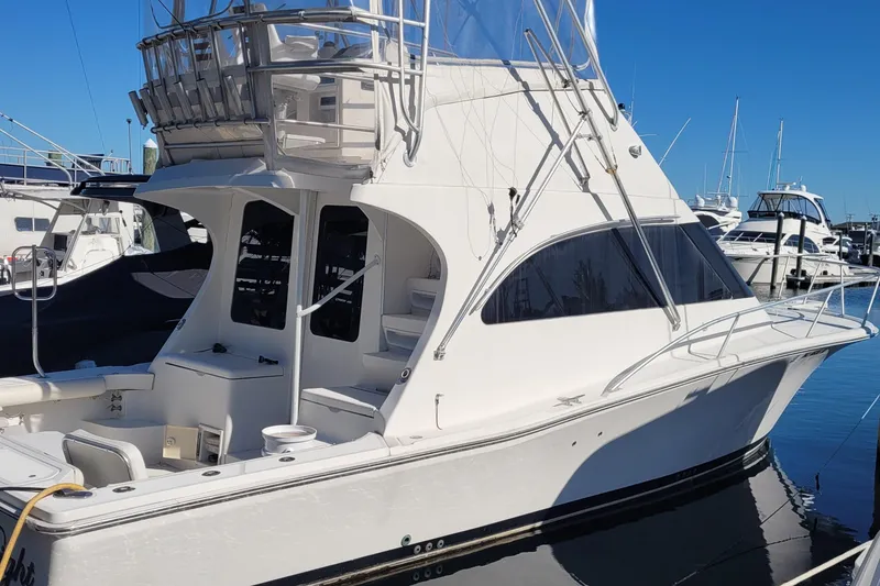 Slide: The Image of 2001 Luhrs 34 Convertible yacht docked at marina under clear blue sky. - 12