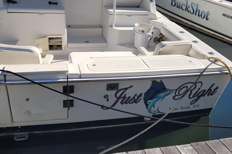 Slide: The Image of 2001 Luhrs 34 Convertible boat named "Just Right" docked in New York marina. - 14