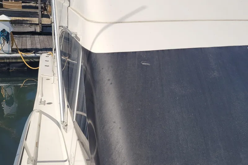 Slide: The Image of 2001 Luhrs 34 Convertible yacht deck view at marina. - 16