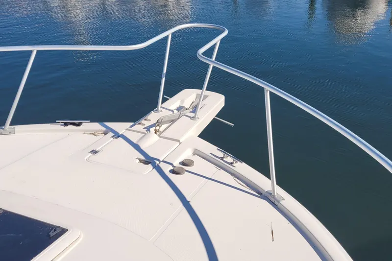 Slide: The Image of Bow of 2001 Luhrs 34 Convertible yacht on calm water. - 19