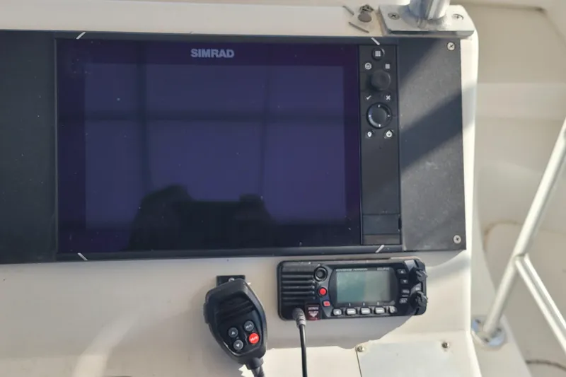 Slide: The Image of Control panel of a 2001 Luhrs 34 Convertible boat with Simrad display and radio. - 25