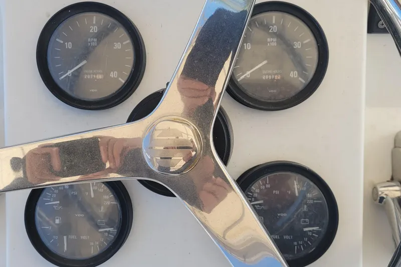 Slide: The Image of Close-up of 2001 Luhrs 34 Convertible boat gauges and steering wheel. - 26