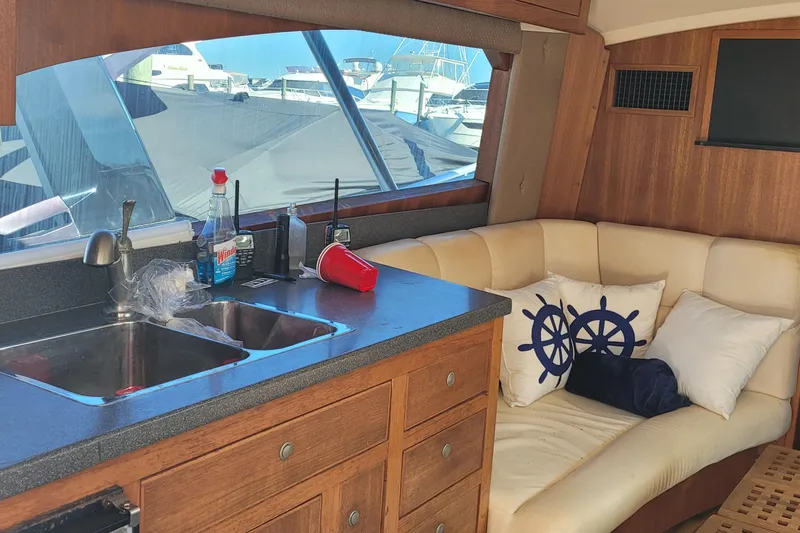 Slide: The Image of Interior of 2001 Luhrs 34 Convertible yacht with kitchenette and seating area. - 32