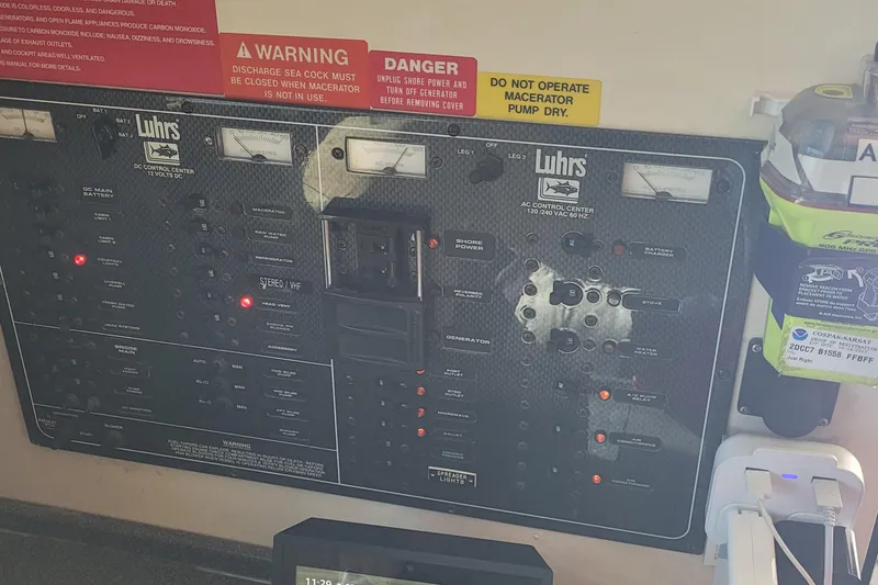 Slide: The Image of Control panel of a 2001 Luhrs 34 Convertible boat with warning labels. - 35
