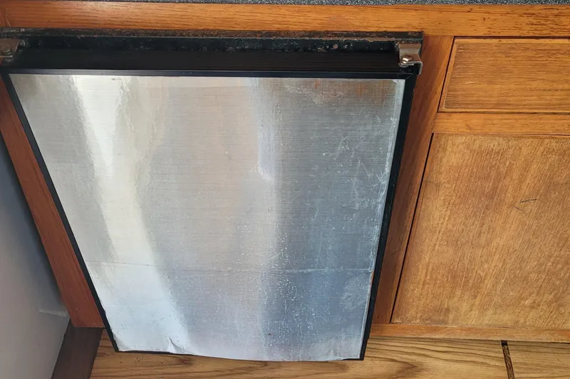 Slide: The Image of 2001 Luhrs 34 Convertible boat interior with metal panel and wooden cabinetry. - 37