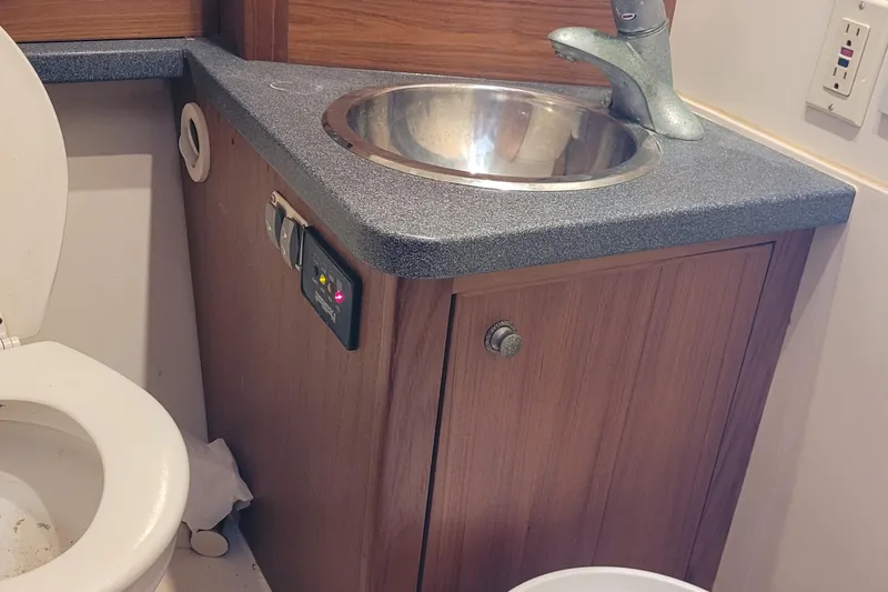 Slide: The Image of 2001 Luhrs 34 Convertible bathroom with sink, faucet, and toilet. - 40