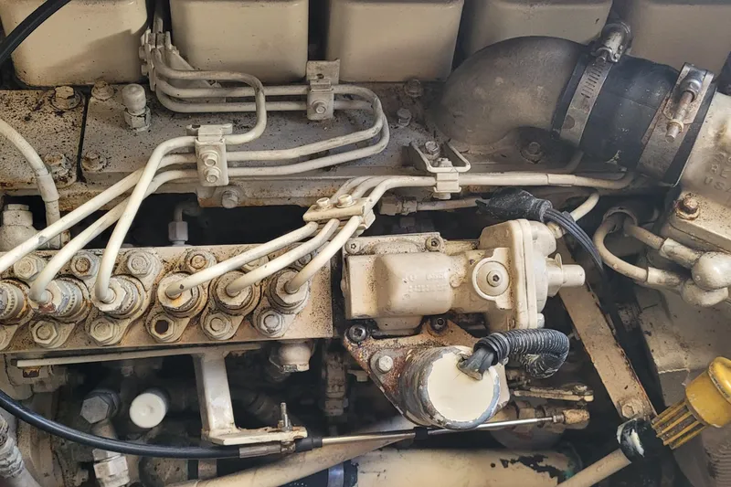Slide: The Image of Engine components of a 2001 Luhrs 34 Convertible boat, showing intricate piping and connections. - 51