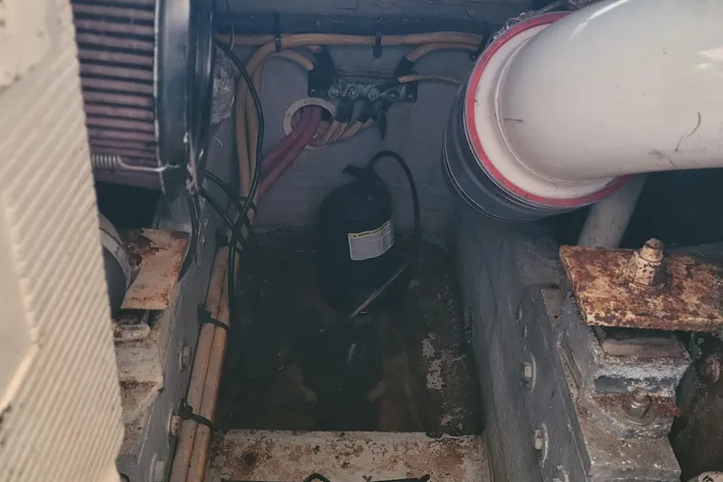 Slide: The Image of Engine compartment of 2001 Luhrs 34 Convertible boat, showing pipes and wiring. - 54