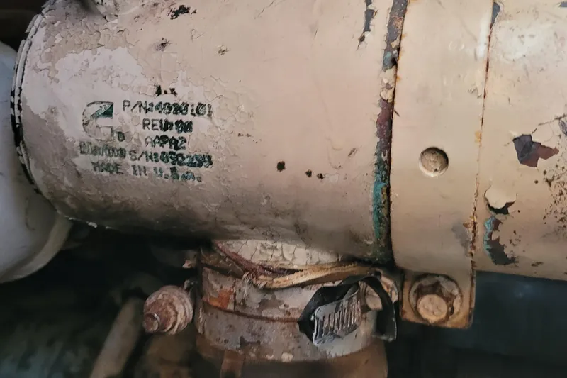 Slide: The Image of Close-up of a weathered engine part on a 2001 Luhrs 34 Convertible boat. - 59