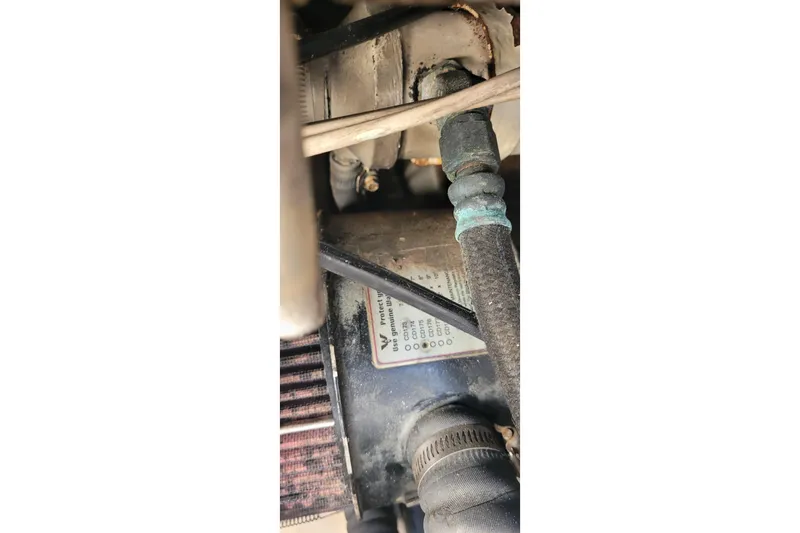 Slide: The Image of Engine component of 2001 Luhrs 34 Convertible boat, showing hoses and connections. - 60