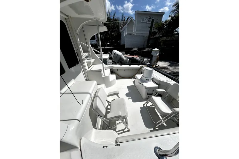 Slide: The Image of 2001 Luhrs 34 Convertible boat deck with seating and equipment under sunny skies. - 7