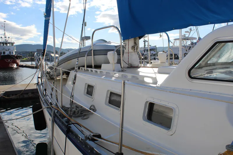 Slide: The Image of 1979 Spencer Yachts 53 sailboat docked at marina under blue sky. - 12