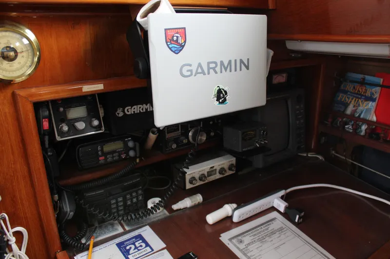Slide: The Image of Navigation equipment on a 1979 Spencer Yachts 53, featuring Garmin devices and marine electronics. - 18