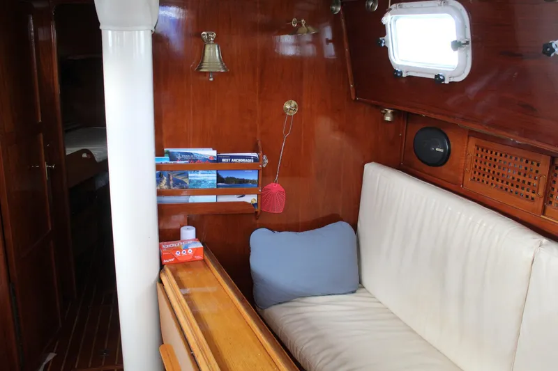 Slide: The Image of Interior of 1979 Spencer Yachts 53, featuring wooden paneling and cozy seating area. - 22