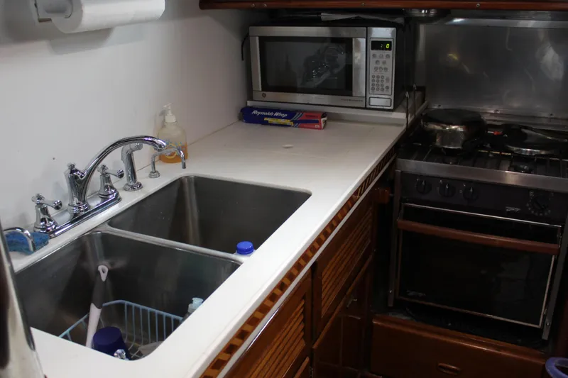 Slide: The Image of 1979 Spencer Yachts 53 kitchen with sink, stove, and microwave. - 25