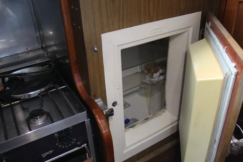 Slide: The Image of Interior of 1979 Spencer Yachts 53 showing kitchen stove and open fridge. - 26