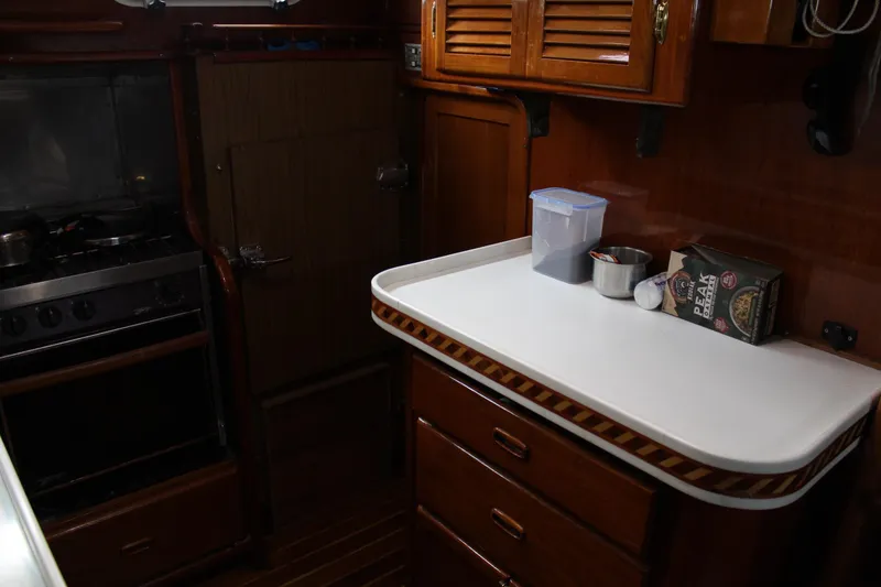 Slide: The Image of 1979 Spencer Yachts 53 interior kitchen with stove, cabinets, and countertop. - 28