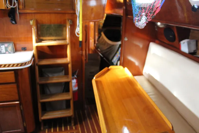 Slide: The Image of Interior of 1979 Spencer Yachts 53, featuring wooden cabinetry and seating area. - 32