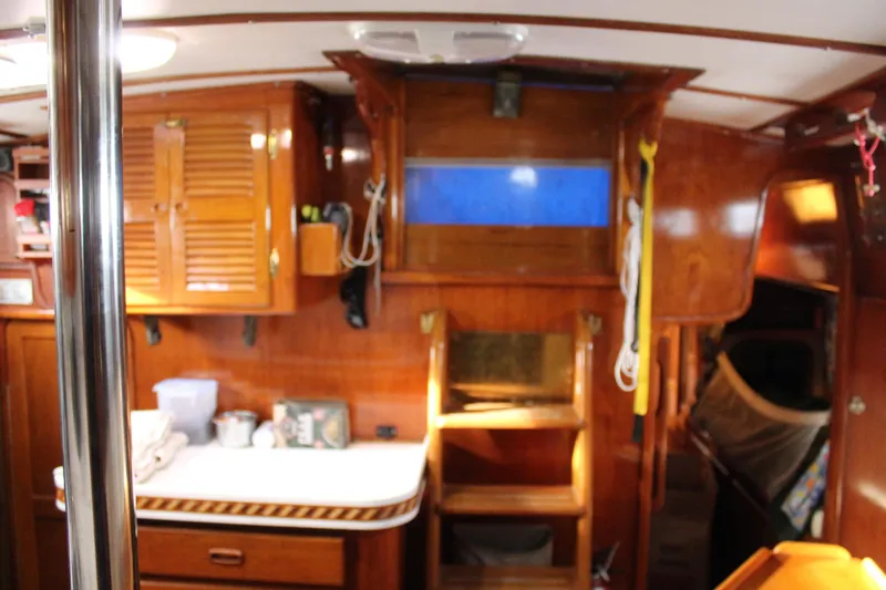 Slide: The Image of Interior of 1979 Spencer Yachts 53, featuring wooden cabinetry and nautical decor. - 33