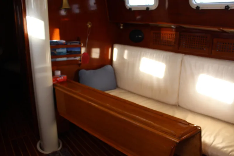 Slide: The Image of Interior of 1979 Spencer Yachts 53, featuring wooden paneling and cushioned seating. - 34