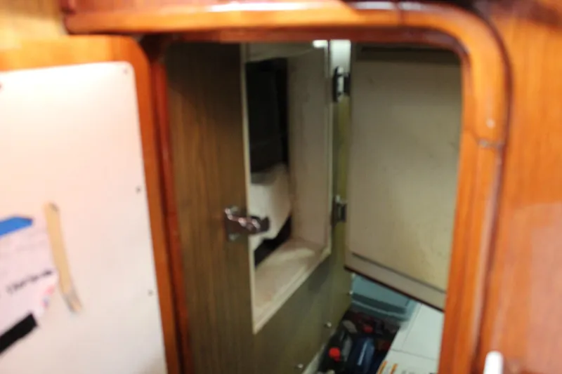 Slide: The Image of Interior view of a 1979 Spencer Yachts 53, featuring wooden cabinetry and storage compartments. - 44
