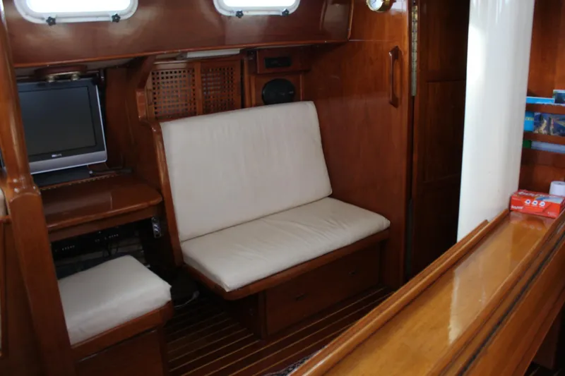 Slide: The Image of Interior of 1979 Spencer Yachts 53, featuring wooden paneling and cushioned seating. - 48