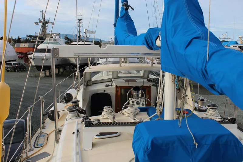 Slide: The Image of 1979 Spencer Yachts 53 sailboat with blue covers, docked in a marina. - 60