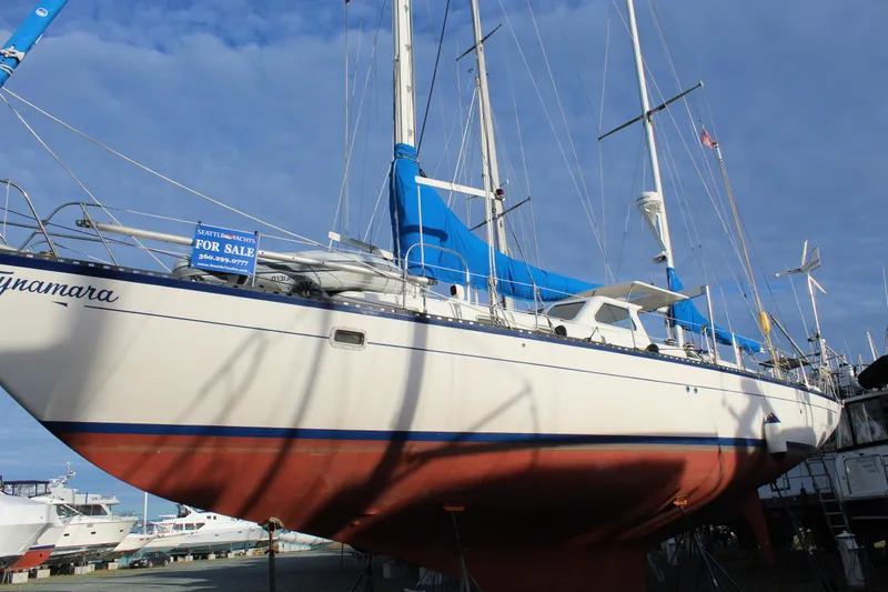 Slide: The Image of 1979 Spencer Yachts 53 sailboat for sale, docked with blue sails and white hull. - 65