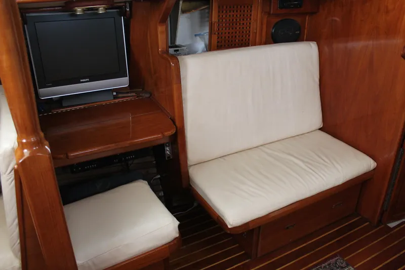 Slide: The Image of Interior of 1979 Spencer Yachts 53, featuring wood paneling and cushioned seating. - 17