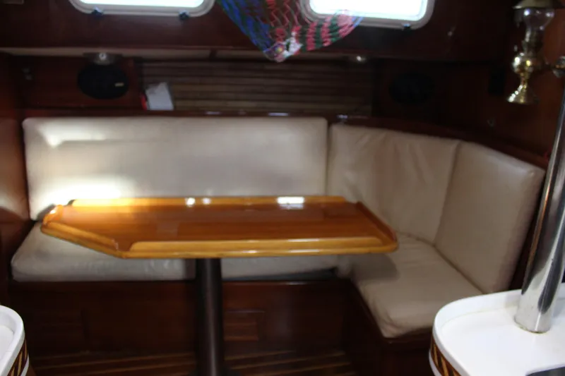 Slide: The Image of Interior of 1979 Spencer Yachts 53, featuring a cozy dining area with wooden table. - 29