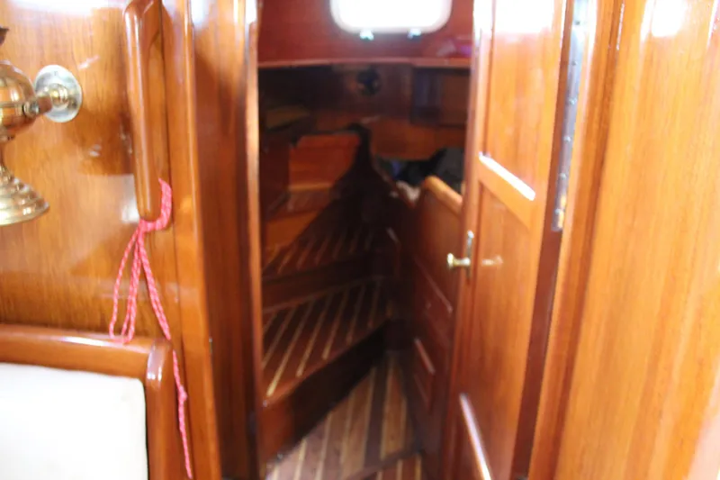 Slide: The Image of Interior of 1979 Spencer Yachts 53, featuring polished wooden paneling and nautical decor. - 30