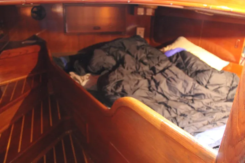 Slide: The Image of Cozy cabin interior of 1979 Spencer Yachts 53, featuring wooden paneling and bedding. - 31