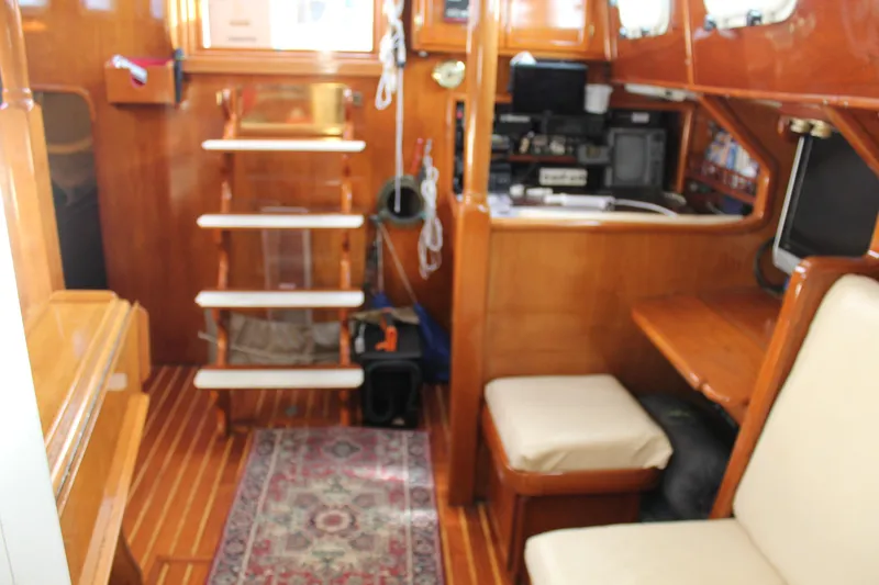 Slide: The Image of Interior of 1979 Spencer Yachts 53, featuring wooden decor and seating area. - 37