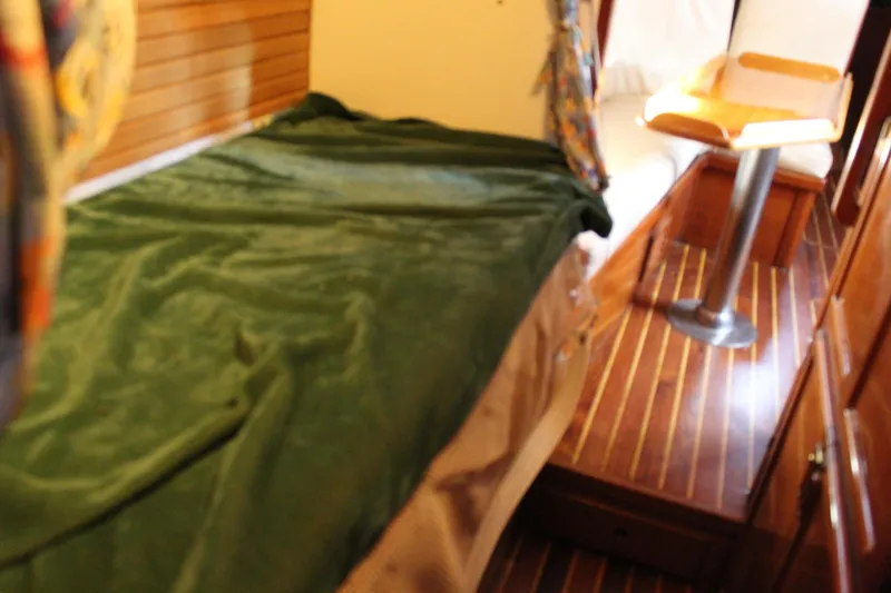 Slide: The Image of Cozy cabin interior of 1979 Spencer Yachts 53 with green bedding and wooden flooring. - 39