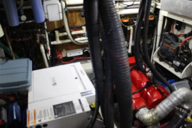 Slide: The Image of Engine room of a 1979 Spencer Yachts 53, featuring machinery and wiring. - 41