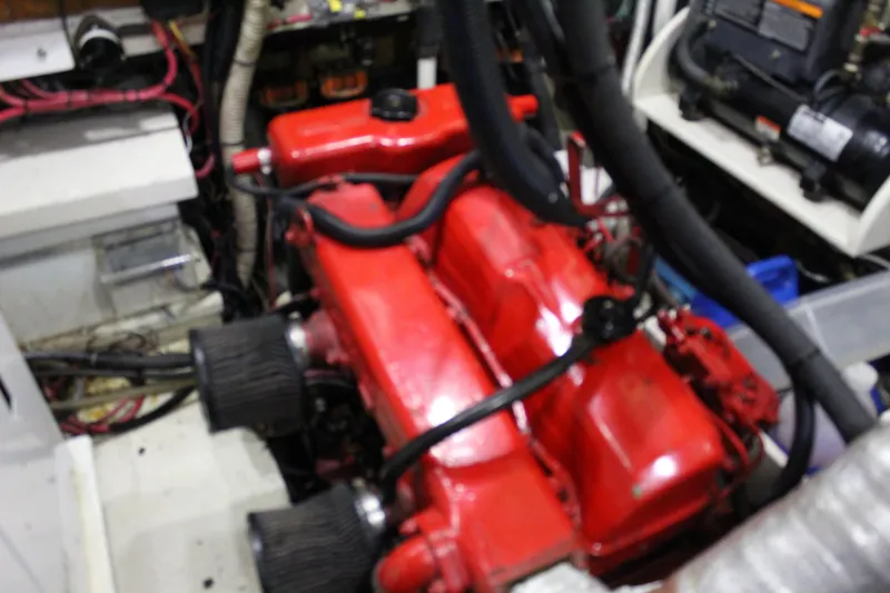 Slide: The Image of Engine room of a 1979 Spencer Yachts 53, featuring a red engine. - 42