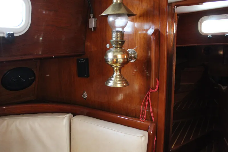 Slide: The Image of Interior of 1979 Spencer Yachts 53, featuring wooden paneling and brass lamp. - 45