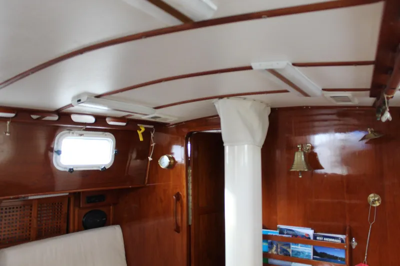 Slide: The Image of Interior of 1979 Spencer Yachts 53, featuring wooden paneling and nautical decor. - 49