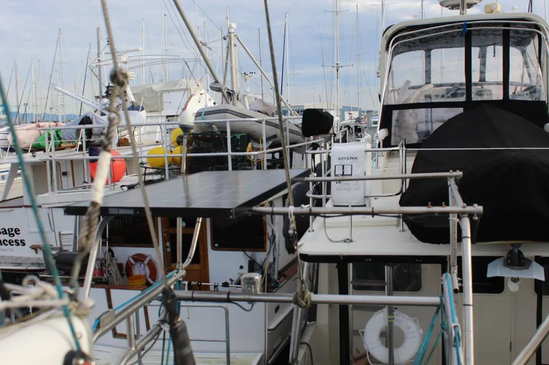 Slide: The Image of Docked yachts at marina, featuring a 1979 Spencer Yachts 53 model. - 57