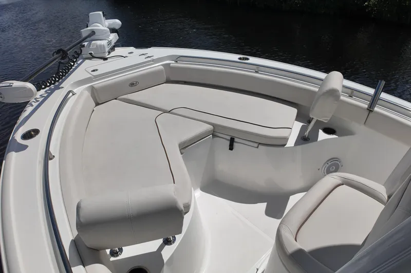 Slide: The Image of 2021 Sea Hunt Ultra 234 boat interior with cushioned seating and sleek design. - 13